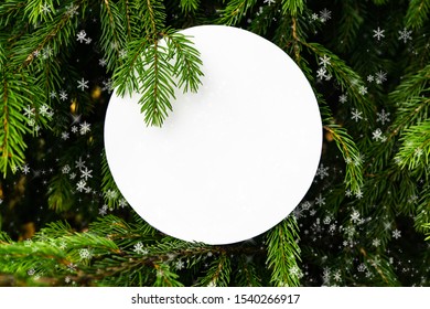 Natural frame of fir branches, snow and light. The concept of a festive mood, Christmas and New Year. Copy space, place for text.Greeting card.Christmas card