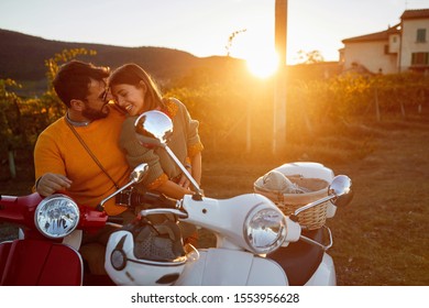 Couple laughing on romantic road trip  at beautiful sunset.