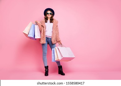 Milan I love you! Full length photo of pretty model lady carry many packs enjoy abroad sales shopping wear fluffy jacket jeans sun specs hat shoes isolated pink background