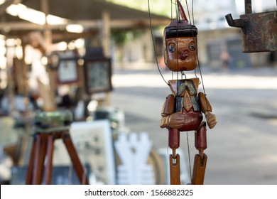 A handcrafted wooden Pinocchio in a street flea market