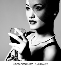 retrato de una hermosa joven con copa de vino, estilización retro en blanco y negro