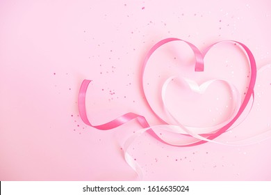Ribbon hearts. Soft pastel background to Valentine`s Day 2021. Light pink sparkles. Flat lay. Romantic wallpaper. Stories background template. Banner lovers day sale. Wedding invitation