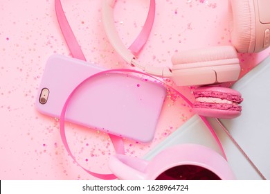 Girl`s pretty pastel set with planner, tea, macaroon, phone and 
headphones. Flat lay. Glitter background. School 2021. School love background. Valentine's Day 2021