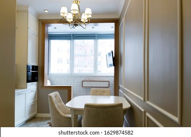 Interior in coffee and beige colors. Kitchen - dining area, balcony and TV