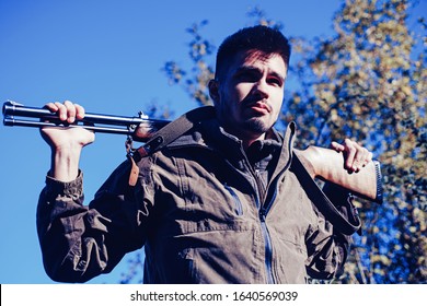 Closed and open hunting season. Man holding shotgun. Poacher with Rifle Spotting Some Deers. Illegal Hunting Poacher in the Forest