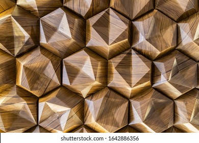3D decorative wall with imitation wood texture for the interior of an unusual hexagonal geometric shape similar to honeycombs. Brown light background with a pattern imitating a tree. Abstract texture