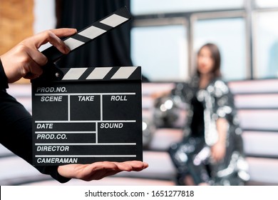 Producing Online Movies and TV Series. Focus On Clapper Board With Woman On Stage On Background. Movie Or Clip Production Backstage