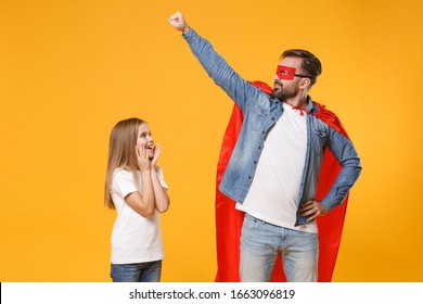 Bearded man in casual clothes Super hero costume have fun with cute child baby girl. Father little kid daughter isolated on yellow background. Love family parenthood childhood concept. Fly gesture arm