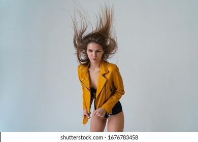 Young fair-skinned girl with long flying hair posing in the studio. wide angle lens and look at the camera.