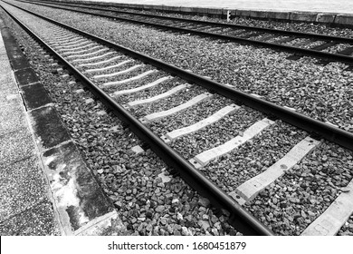 Two railway lines in diagonal. The nearest one works as a perfect escape line to the left side of the composition to infinity. Railroad tracks to infinity and beyond. Train tracks. pattern-like scape