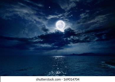 満月と海に映る夜空、美しい雲。NASA から提供されたこの画像の要素