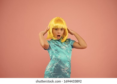 Girl yellow wig. Cosplay character concept. Japanese style. Eastern trends for teens. Hobby and entertainment. Pop culture. Anime fan. Child cute cosplayer. Anime emotional expression. Anime admirer.