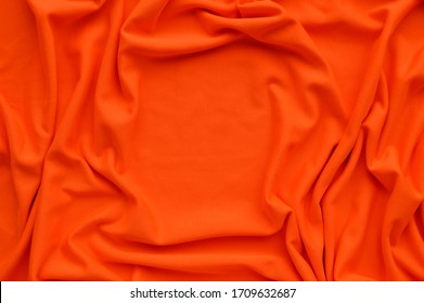 Oranje stof textuur achtergrond, oranje stof verfrommeld achtergrond, close-up