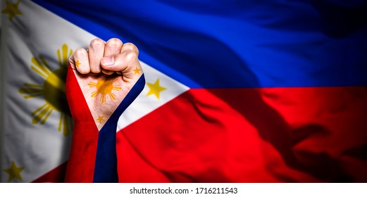 男性の拳、拳の旗、フィリピンの国、強さ、力、紛争の概念に描かれたフィリピンの旗のバナー。ぼやけた背景に、テキストに適した場所。