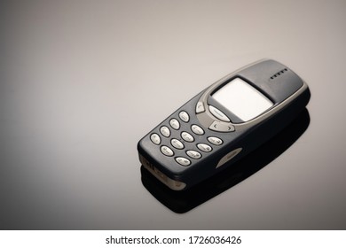 An outdated mobile phone with a screen for copying space on a gray gradient background. The minimalist trend. smartphone. with copy space for text.