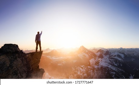 Compuesto de aventura de fantasía con un hombre en la cima de un acantilado de montaña con un paisaje dramático en el fondo durante el atardecer o el amanecer. Paisaje de la Columbia Británica, Canadá.