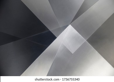 Steel sheets. Metal panels. Abstract modern architecture exterior or interior detail. Industrial background in hi-tech style. Polygonal geometric pattern of triangles in shades of metallic gray color.