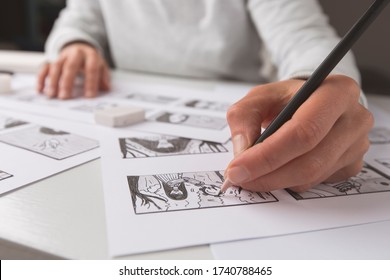 The animator artist draws in pencil a storyboard for the cartoon. Pre-production for the video film. The designer creates sketches for the comics.