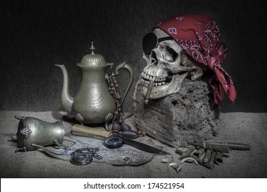 Still life, pirate skull with cigar in the mouth on the log, compass on ancient map, brass tea pots knife and pocket 