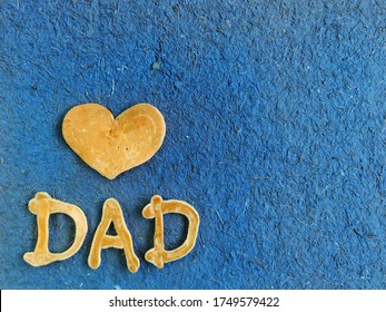 lettering text i love father’s day breakfast heart dad in the form of pancakes on a blue background of interesting texture. father's day