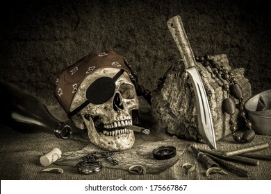 Still life, pirate skull with cigar in the mouth on the log, compass on ancient map, knife brass tea pot and pocket watch