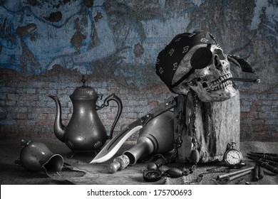 Still life, pirate skull with cigar in the mouth on the log, compass on ancient map, knife brass tea pot and pocket watch with grunge wall background
