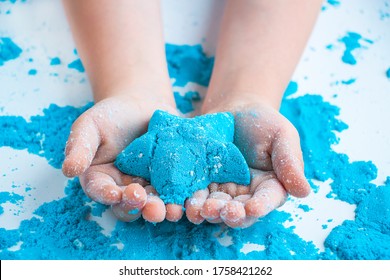 Creatividad infantil. Juegos de arena cinéticos para el desarrollo infantil en casa. Terapia de arena. Manos de los niños haciendo moldes.Enfoque selectivo, ruido artificial de crominancia, artefactos de compresión