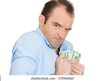 Closeup portrait of greedy banker executive CEO boss, corporate employee funny looking man, shaking holding dollar banknotes scared to loose money, suspicious isolated on white background. Expressions