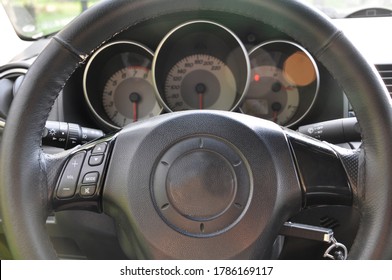 Car dashboard with tachometer and speedometer.