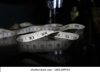 This is a measuring tape.
And a sewing machine with it.
Picture taken at night.
Only the camera flash has been used.


