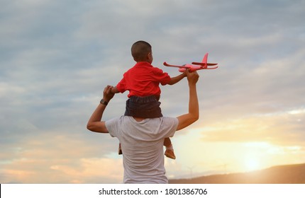 父の日。お父さんと赤ちゃんの息子が屋外で一緒に遊ぶ紙飛行機