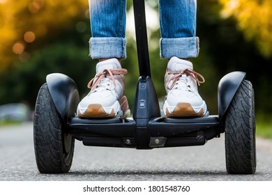 Mlada djevojka vozi Board na otvorenom u parku, aktivna žena balansira na modernom električnom Boardu, koncept budućnosti, alternativni prijevoz, ekologija i okoliš.