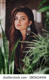 Portrait of beautiful young brunette woman with makeup on nature