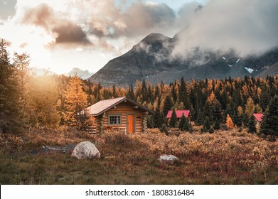 Wooden huts with sunshine in autumn forest at Assiniboine provincial park, Canada