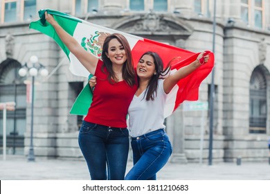 Mexican soccer fans with mexican flag outdoors in Mexico