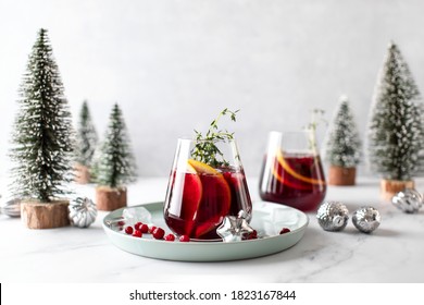 Cranberry-Gin-alkoholischer Cocktail mit Grapefruit und Thymian, serviert an Winterferien, dekorierter Tisch, Vorderansicht