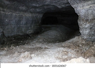 old abandoned galleries, adits, for extraction and processing of natural stone and gypsum cave. Dark eerie stone, quartz tunnels deep in earth. Various rocks, geological and speleological research.