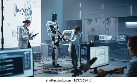 In Robotics Technology Development Laboratory Diverse Team of Engineers Work on a Bionics Exoskeleton Prototype. Scientists Design Powered Armor Suit to Help Disabled People and Hard Labor Workers