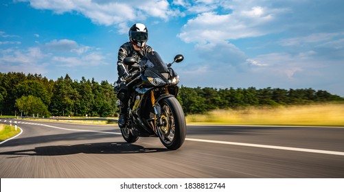 motorbike on the road riding. having fun driving the empty road on a motorcycle tour journey. copyspace for your individual text. Fast Motion Blur effect