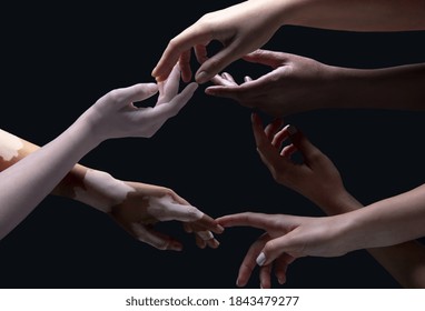 Open hearts. Hands of different people in touch isolated on black studio background. Concept of relation, diversity, inclusion, community, togetherness. Weightless touching, creating one unit.