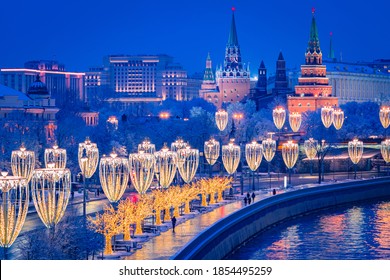 Christmas Moscow. Embankment in capital of Russia. New Year's decorations on Moscow embankment. Russian city in Christmas illumination. Moscow river on a winter night. Bird's-eye view of city Russia.