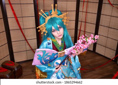 Cute white teenage girl cosplaying japanese character style indoors