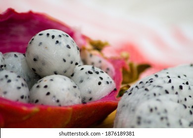 Dragon fruit pitaya scooped into balls with melon baller and placed in shell close up