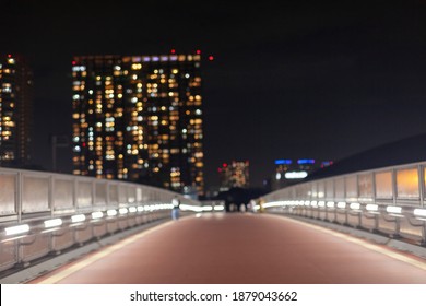 Night view of the city, sidewalks and skyscrapers in the back blurred