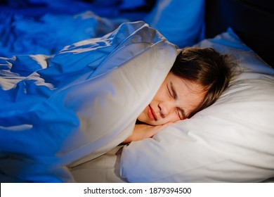 A girl naps in bed in her room, sees a nightmare in sleep. restless, unhealthy sleep in children after watching a horror movie, computer game.