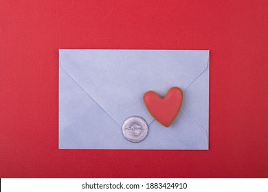 blue envelope with a wax stamp of love and a red heart on a red background. love letter, background for Valentine's day, mother's day