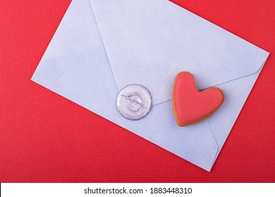 blue envelope with a wax stamp of love and a red heart on a red background. love letter, background for Valentine's day, mother's day