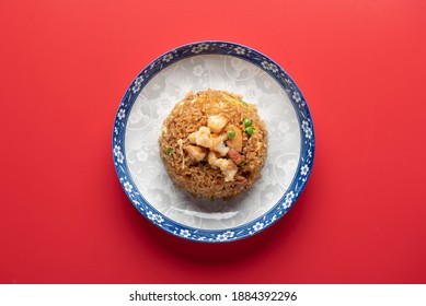 Table Top Angled Chinese XO Fried Rice served in Blue Traditional Chinese Plate on Red Background