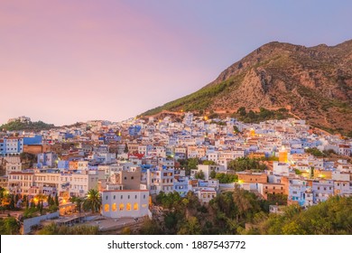 A scenic sunset or sunrise cityscape view over Chefchaouen, Morocco, known as the Blue Pearl with its shades of blue on the town's historic buildings.