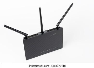 Dual-band gigabit Wi-Fi router with  three antennas. Wireless device on white background.